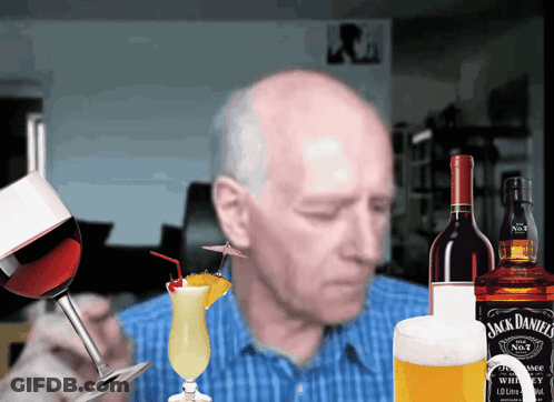 A Bottle Of Jack Daniel 'S Whiskey Sits Next To A Bottle Of Wine GIF