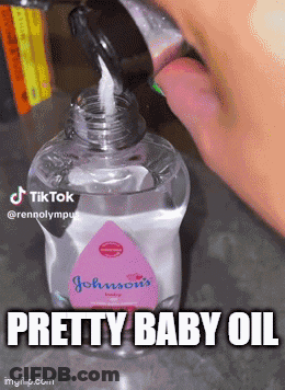 A Bottle Of Johnson 'S Baby Oil Is Poured Into Someone 'S Mouth GIF