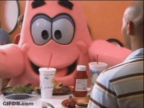 A Bottle Of Ketchup Sits On A Table Next To A Man In A Blue Shirt GIF