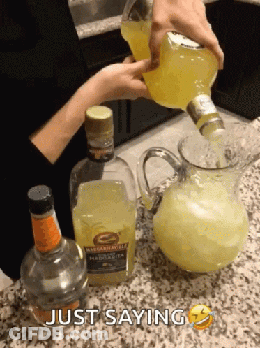 A Bottle Of Margaritaville Is Being Poured Into A Pitcher Of Ice GIF