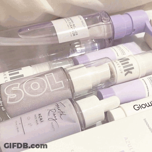 A Bottle Of Milk Makeup Sits Next To A Bottle Of Sol And A Bottle Of Glow GIF