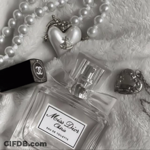 A Bottle Of Miss Dior Cherie Eau De Toilette Surrounded By Pearls GIF