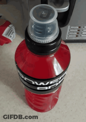 A Bottle Of Red Powerade Sits On A Counter GIF