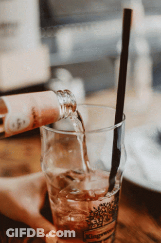 Wine Bottle Poured Into Glass With Straw GIF