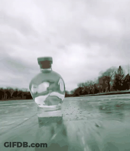 A Bottle With A Cork Is In The Water GIF