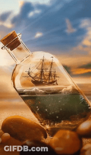 A Bottle With A Ship Inside Of It On A Beach GIF