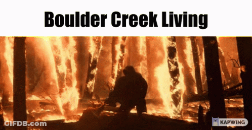 A Boulder Creek Living Poster With A Man Standing In Front Of A Burning Forest GIF