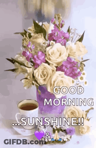 A Bouquet Of Flowers And A Cup Of Coffee On A Table With The Words `` Good Morning Sunshine '' Written On It . GIF