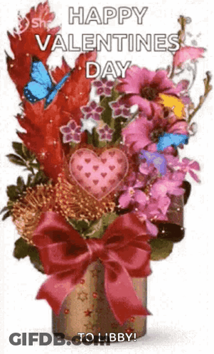 A Bouquet Of Flowers In A Vase With A Bow And A Heart On It . GIF