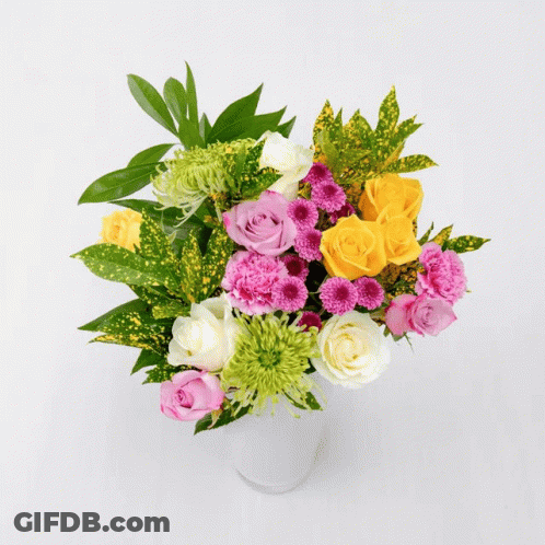 A Bouquet Of Flowers Including Pink Roses And A Yellow Lily GIF