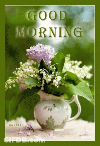 A Bouquet Of Lily Of The Valley Flowers In A Pitcher On A Green Background GIF