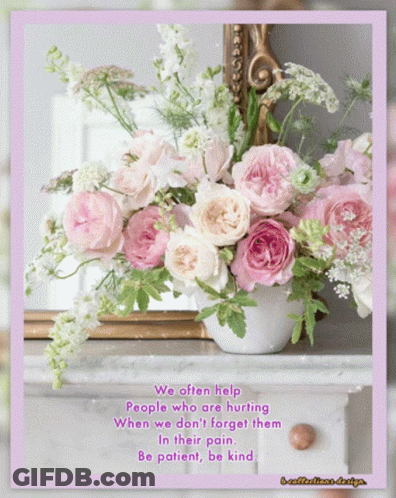 A Bouquet Of Pink And White Flowers In A Vase With A Quote GIF