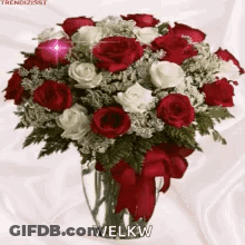 A Bouquet Of Red And White Roses In A Vase That Says Welkw GIF