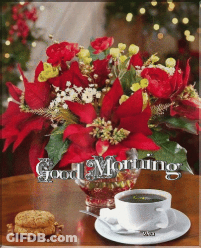 A Bouquet Of Red Flowers Sits On A Table Next To A Cup Of Coffee And A Plate Of Cookies GIF