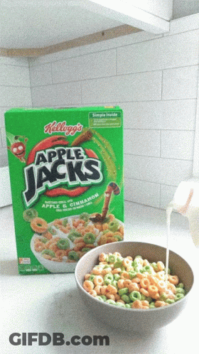 A Bowl Of Apple Jacks Cereal Next To A Box Of Cereal GIF