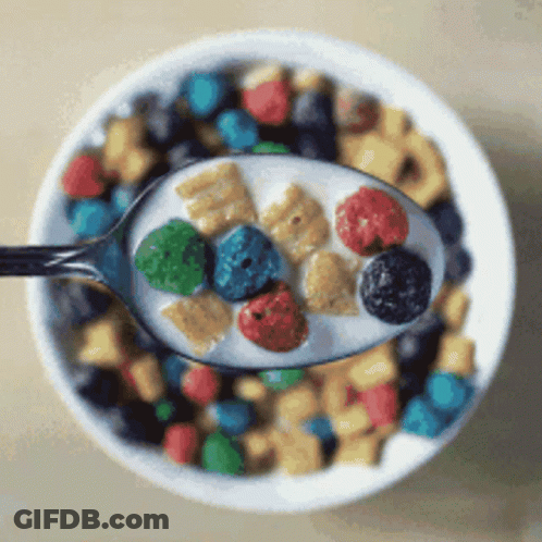 A Bowl Of Cereal With A Spoon Full Of Cereal And Milk GIF