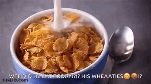 A Bowl Of Cornflakes With Milk Being Poured Into It . GIF