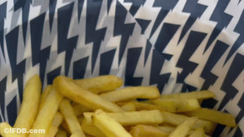 A Bowl Of French Fries With A Lightning Bolt Pattern On The Paper GIF