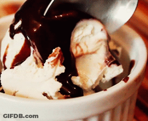 A Bowl Of Ice Cream With Chocolate Sauce And A Spoon In It GIF