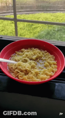 A Bowl Of Noodles Sits On A Window Sill With Jp Written On The Bottom GIF