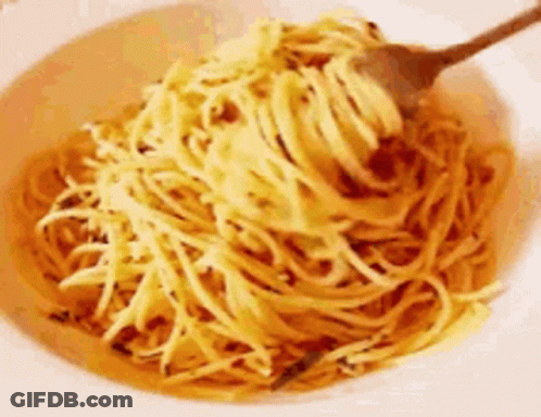 A Bowl Of Noodles With A Fork In It . GIF