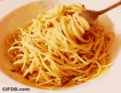 A Bowl Of Noodles With A Spoon In It GIF
