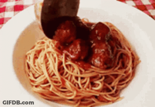 A Bowl Of Spaghetti And Meatballs With A Spoon In It GIF