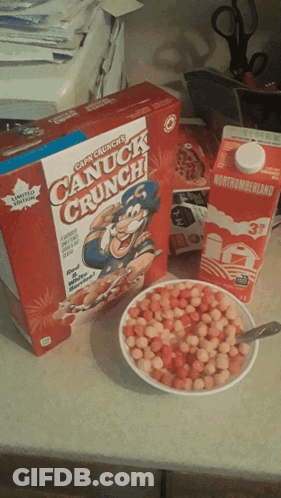 A Box Of Canuck Crunch Cereal Next To A Bowl Of Cereal And A Carton Of Milk GIF