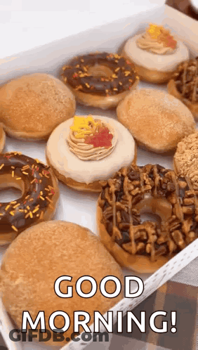 A Box Of Donuts With Sprinkles And Frosting And The Words `` Good Morning '' Written On It . GIF