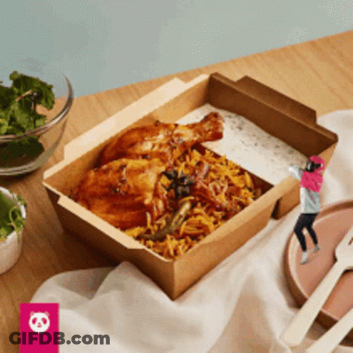 A Box Of Food With Chicken And Rice On A Table With A Panda Logo In The Corner GIF