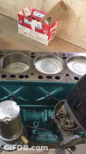 A Box Of Huskies Toothpaste Sits On The Floor Next To A Cylinder Head GIF