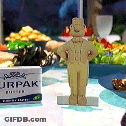 A Box Of Jrpak Butter Sits On A Table Next To A Figurine GIF