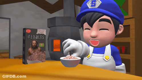 A Box Of Pebbles Sits On A Table Next To A Cartoon Character GIF