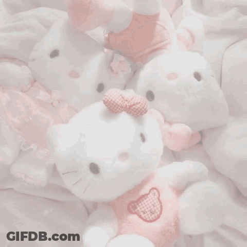 A Box Of Pink Cakes With Strawberries On Top GIF