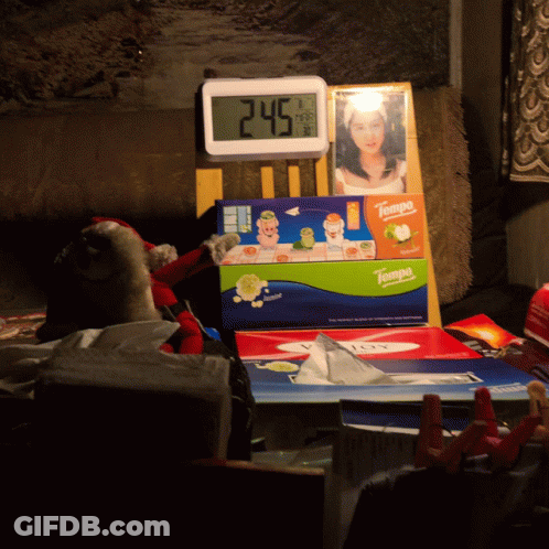 A Box Of Tampa Tissues Sits On A Table Next To A Clock GIF