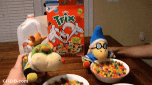 A Box Of Trix Cereal Sits On A Table Next To Two Stuffed Animals GIF