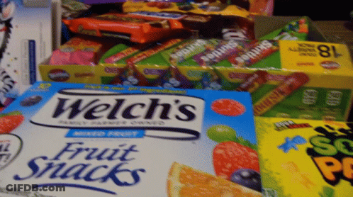 A Box Of Welch 'S Fruit Snacks Sits Next To Other Boxes Of Candy GIF