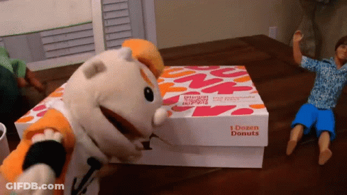 A Box That Says 1 Dozen Donuts Sits On A Table GIF
