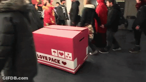 A Box That Says Love Pack On It In A Crowded Area GIF