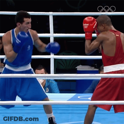 A Boxer Wearing Red Gloves That Say Rio 2016 GIF