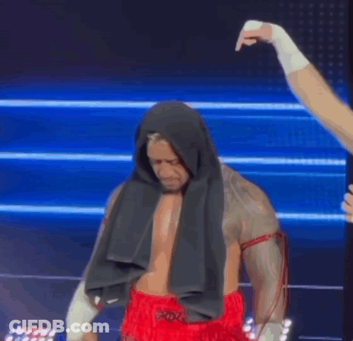 A Boxer With A Towel Wrapped Around His Head Is Getting Ready To Fight . GIF