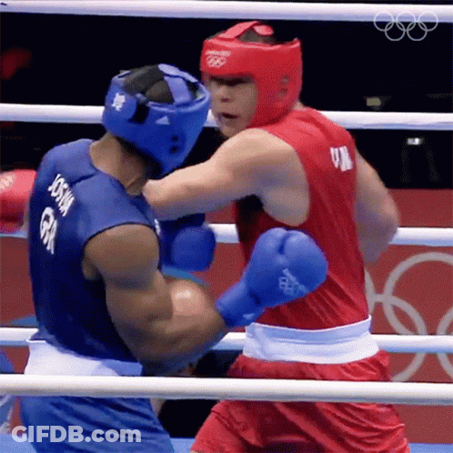 A Boxer With The Name Joshua On His Back Is Fighting Another Boxer GIF