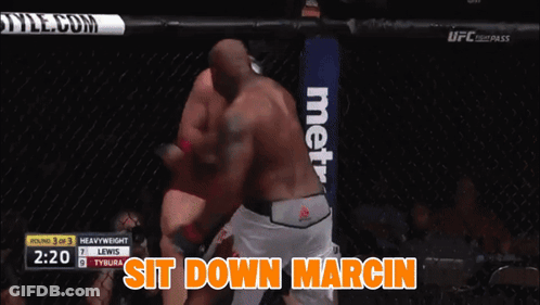 A Boxing Match Between Lewis And Tybura With The Words Sit Down Marcin On The Bottom GIF