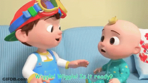 A Boy And A Baby Are Talking To Each Other On A Couch . GIF