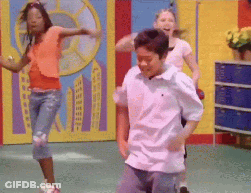 A Boy And A Girl Are Dancing In A Room . GIF