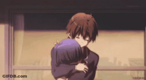 A Boy And A Girl Are Hugging Each Other In A Room . GIF