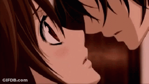 A Boy And A Girl Are Kissing Each Other In A Close Up Of Their Faces . GIF
