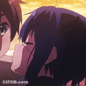 A Boy And A Girl Are Kissing In A Cartoon . GIF