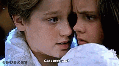 A Boy And A Girl Are Looking At Each Other And The Boy Is Asking The Girl If She Can Keep Him . GIF