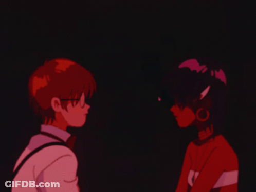 A Boy And A Girl Are Looking At Each Other And The Girl Is Wearing A Shirt That Says Sai GIF